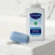 Cuticura Mildly Medicated Original Body Powder next to bar of soap