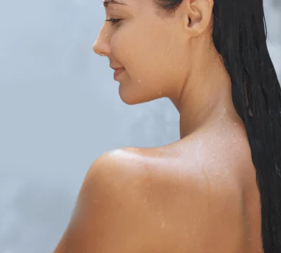 woman in shower using mildly medicated soap